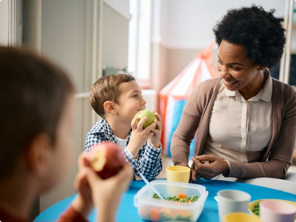 Image of Woman with Kids eating apples
