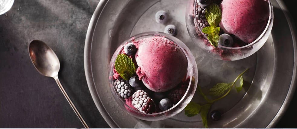 A frozen berry dessert garnished with fresh berries