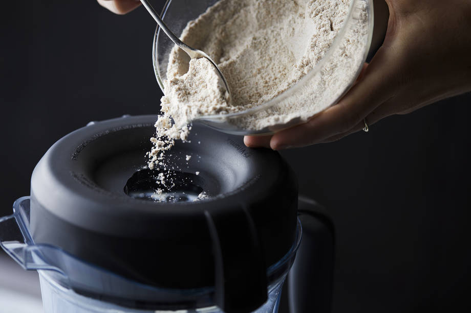 pouring dry ingredients into blender container