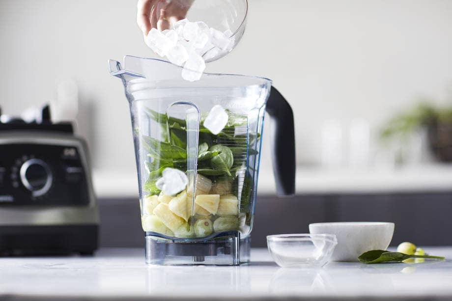 going green smoothie ingredients in a blender container