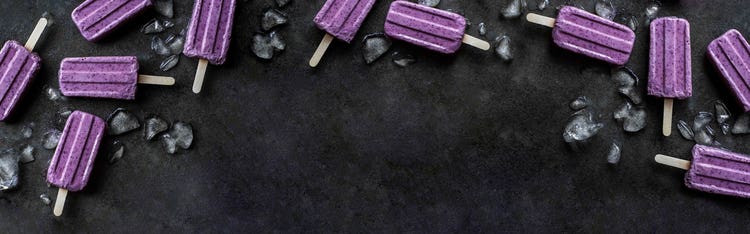 Paletas heladas moradas sobre fondo negro (Imagen principal)